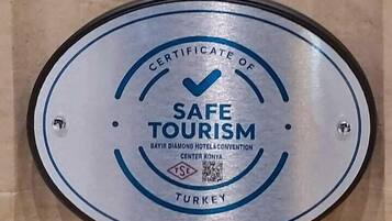 Two plaques: one for the Bayir Diamond Hotel & Convention Center and another for Safe Tourism certification.