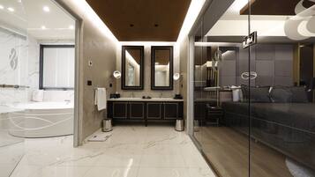 A modern bathroom with a large mirror, a bathtub, and a shower area.