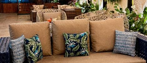 A lounge area with a sofa set, a coffee table with snacks, and a bottle of drink.