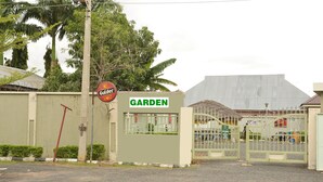 A gated entrance to a garden area with a sign reading "GARDEN" and a sign for "Gulbet."