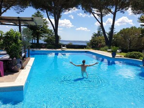 Seasonal outdoor pool, open 11:00 AM to 7:00 PM, pool umbrellas