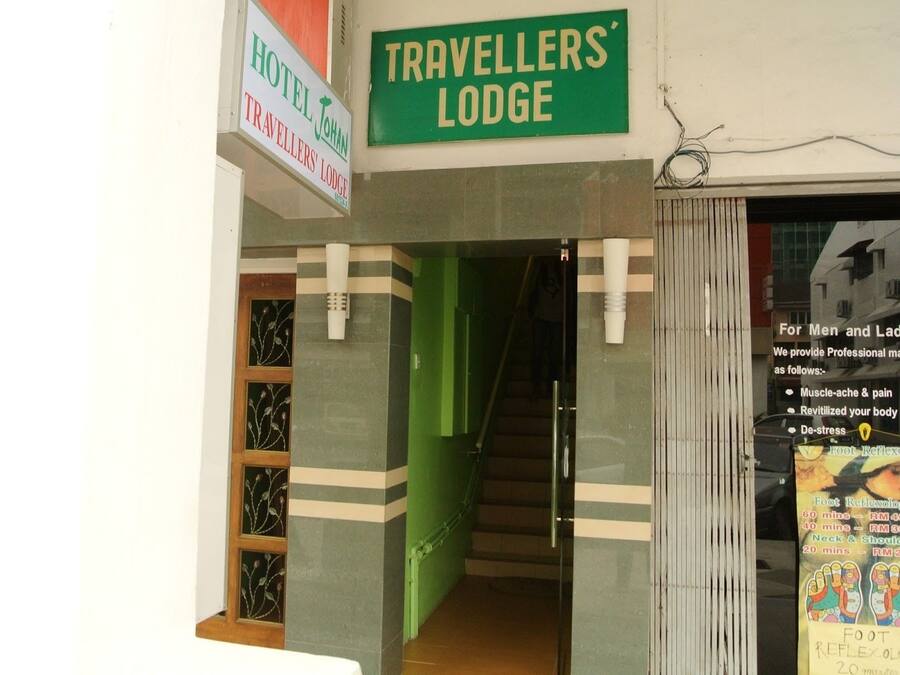 The entrance to Travellers' Lodge with a sign indicating it is a hotel.