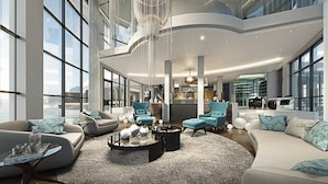 A spacious, modern living area with high ceilings, large windows, and contemporary furniture. - Ocean View Penthouse (Cape Town)