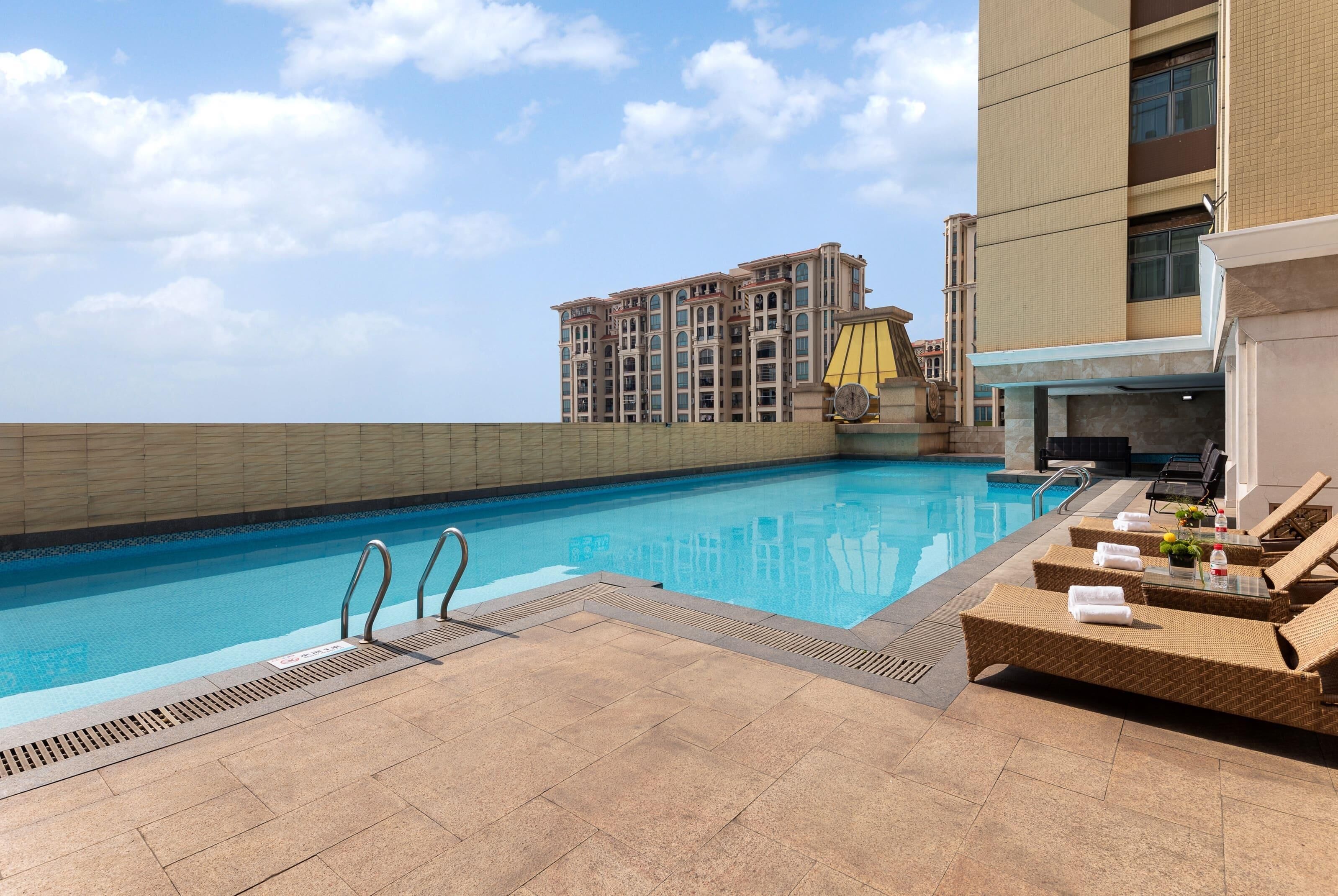 Seasonal outdoor pool, open 1:00 PM to 7:30 PM, pool umbrellas