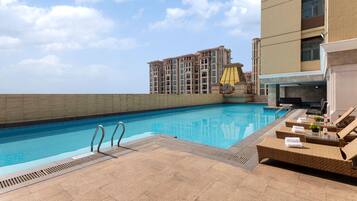 Seasonal outdoor pool, open 1:00 PM to 7:30 PM, pool umbrellas