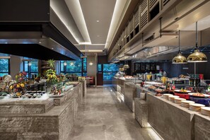 A modern kitchen with a central island, ample counter space, and a view of the outdoors.