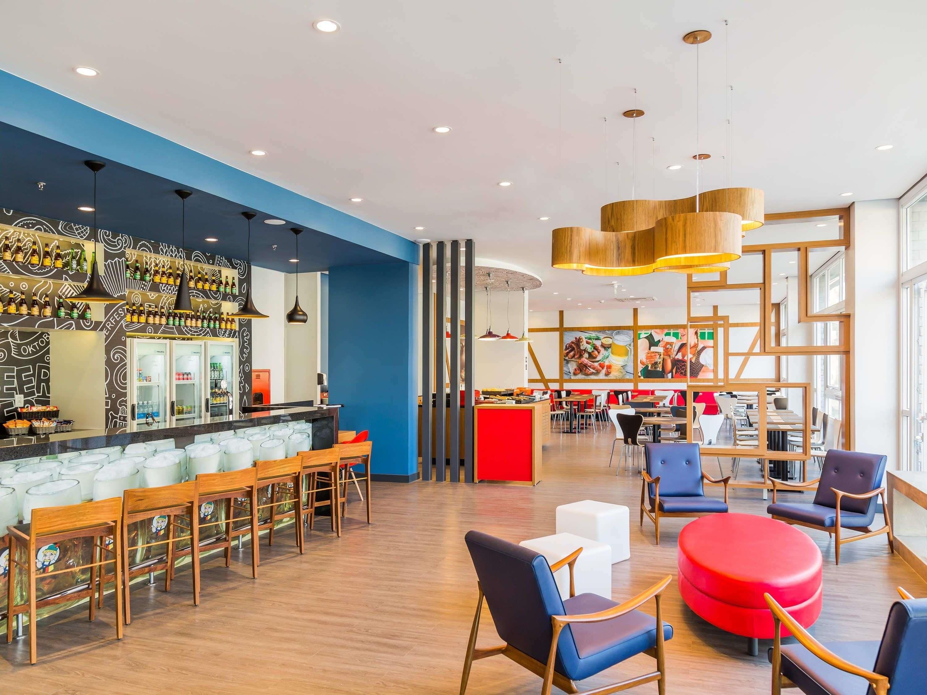 A modern bar area with seating and a counter.
