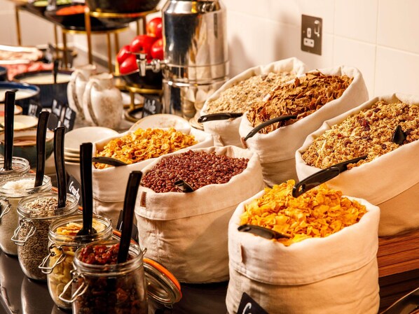 A buffet with various food items in bags and jars. - ibis London Canning Town (London)