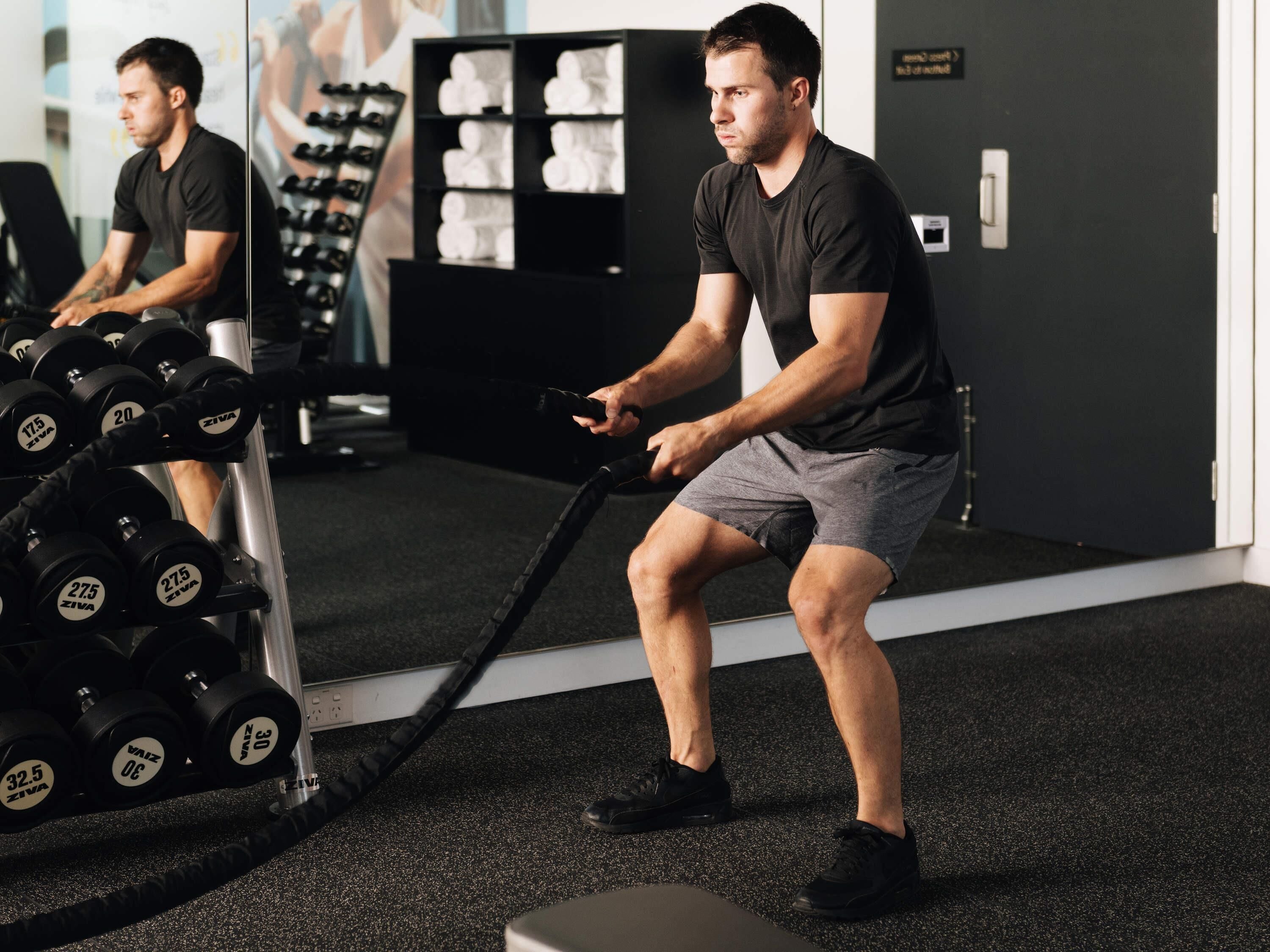 A gym with exercise equipment, including dumbbells and a cable machine.