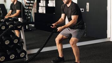A gym with exercise equipment, including dumbbells and a cable machine.