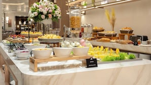 Un buffet proposant divers plats et une pancarte indiquant « chips de bananes plantains, spécialité chilienne ».