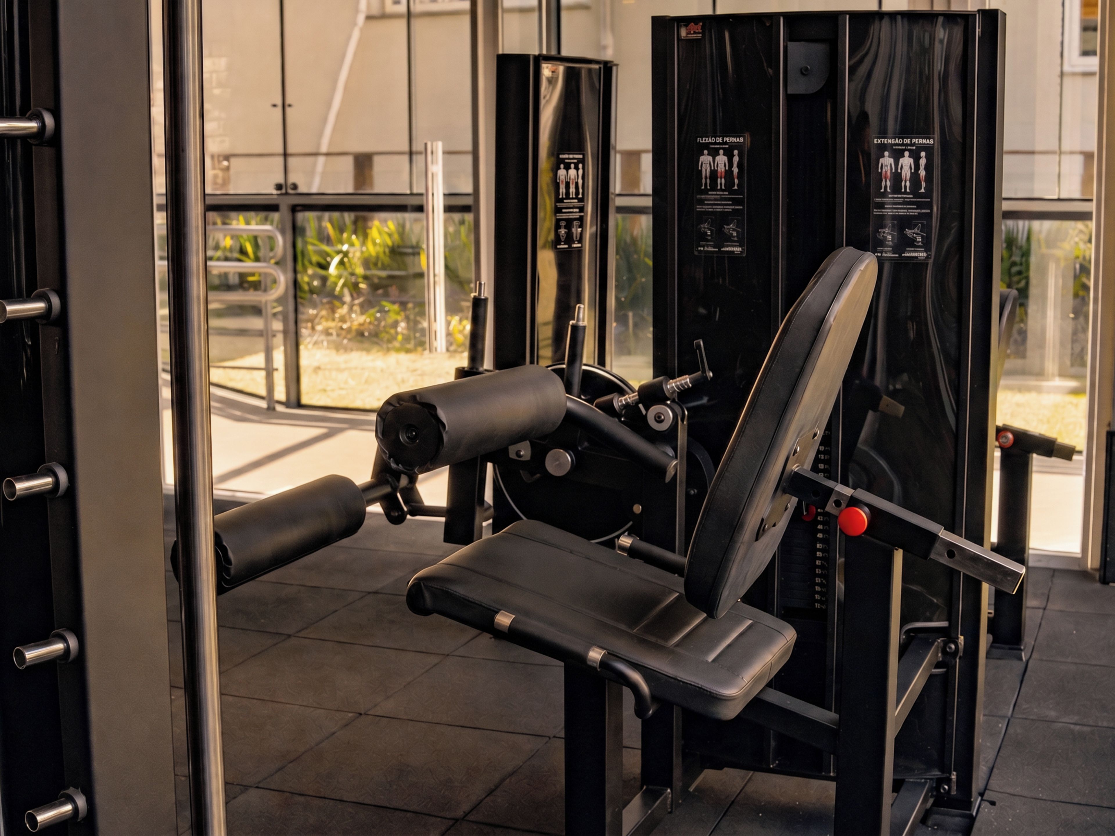 A gym with exercise equipment, including a bench press and a squat rack.