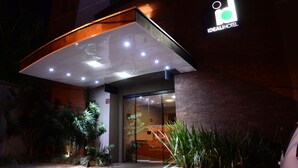 The exterior of the Idealihotel with a modern entrance, glass doors, and a signboard.