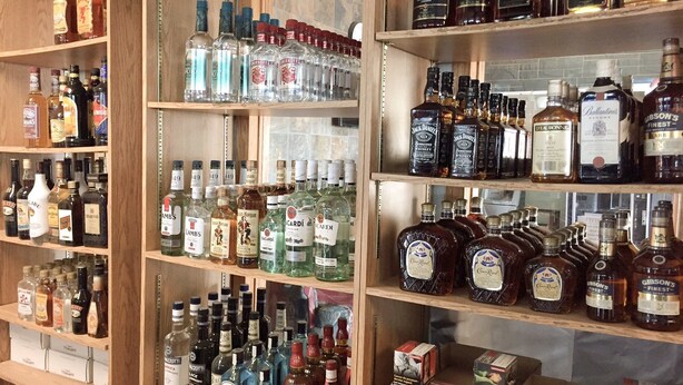 A liquor store with shelves stocked with various bottles of alcohol. - Hi Valley Motor Inn (Valleyview)
