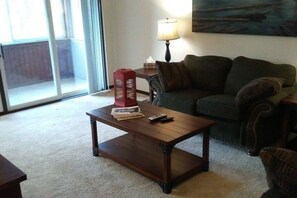 Living Room w/love seats, patio access, and Roku TV