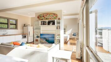 Apartment, 1 Bedroom, Ocean View | Living room | Flat-screen TV, DVD player