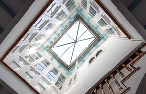 A high ceiling with a skylight and a view of the building's interior structure.