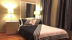 A bedroom with a bed, nightstands, a mirror, and curtains. - Affordable Month to Month In The Heart Of Chicago. 30 Day Minimum Bookings. (Chicago)