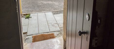 An open door leading to a parking area with a clear view of the surroundings.