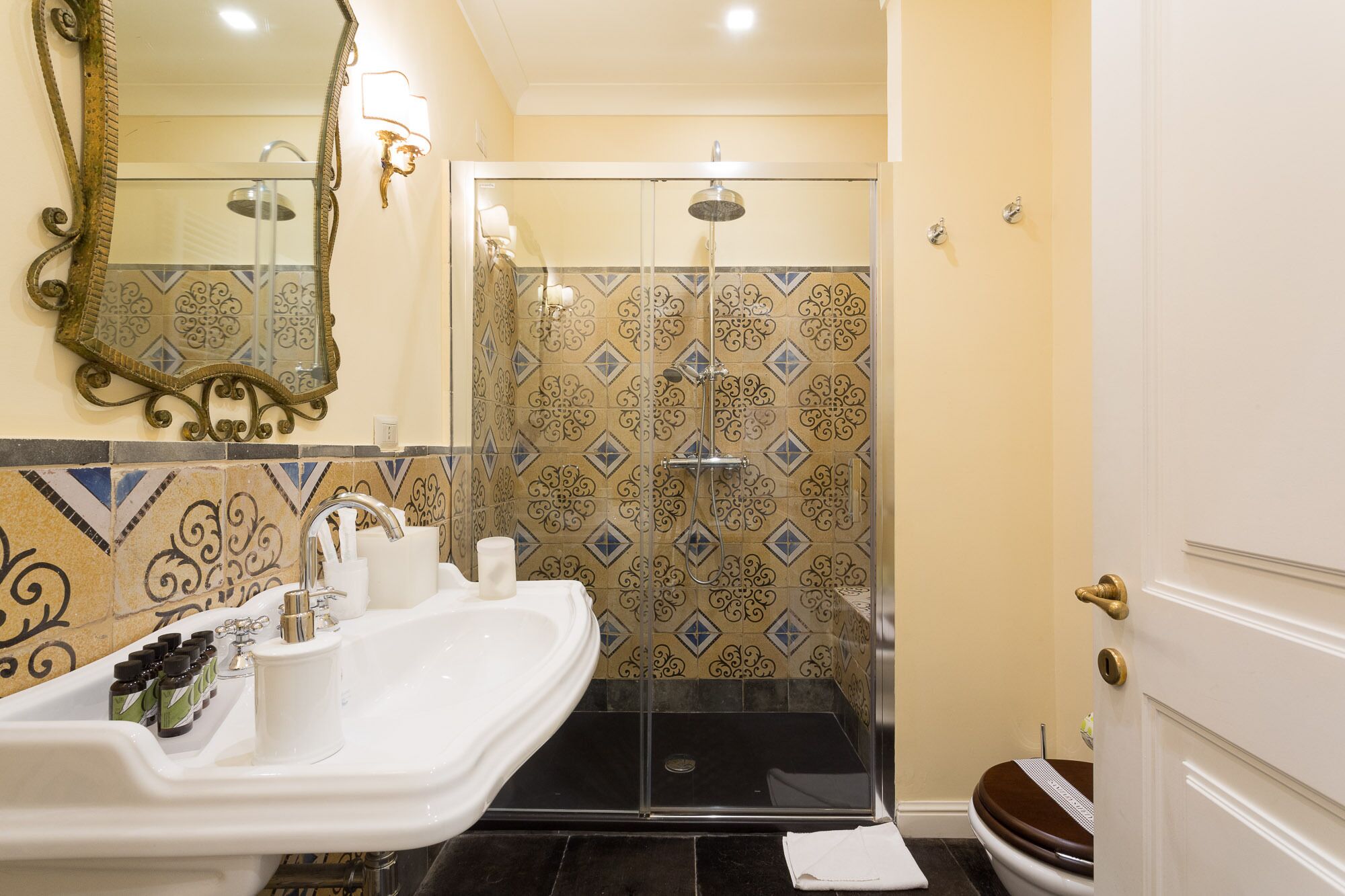 A bathroom with a shower, sink, and toilet.