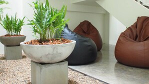 A modern interior with concrete planters and bean bags. - Shunli Hostel (Phuket)