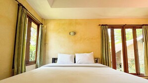 A large bed with white linens in a room with yellow walls and large windows. - Baanbali Beach Resort (Pranburi)