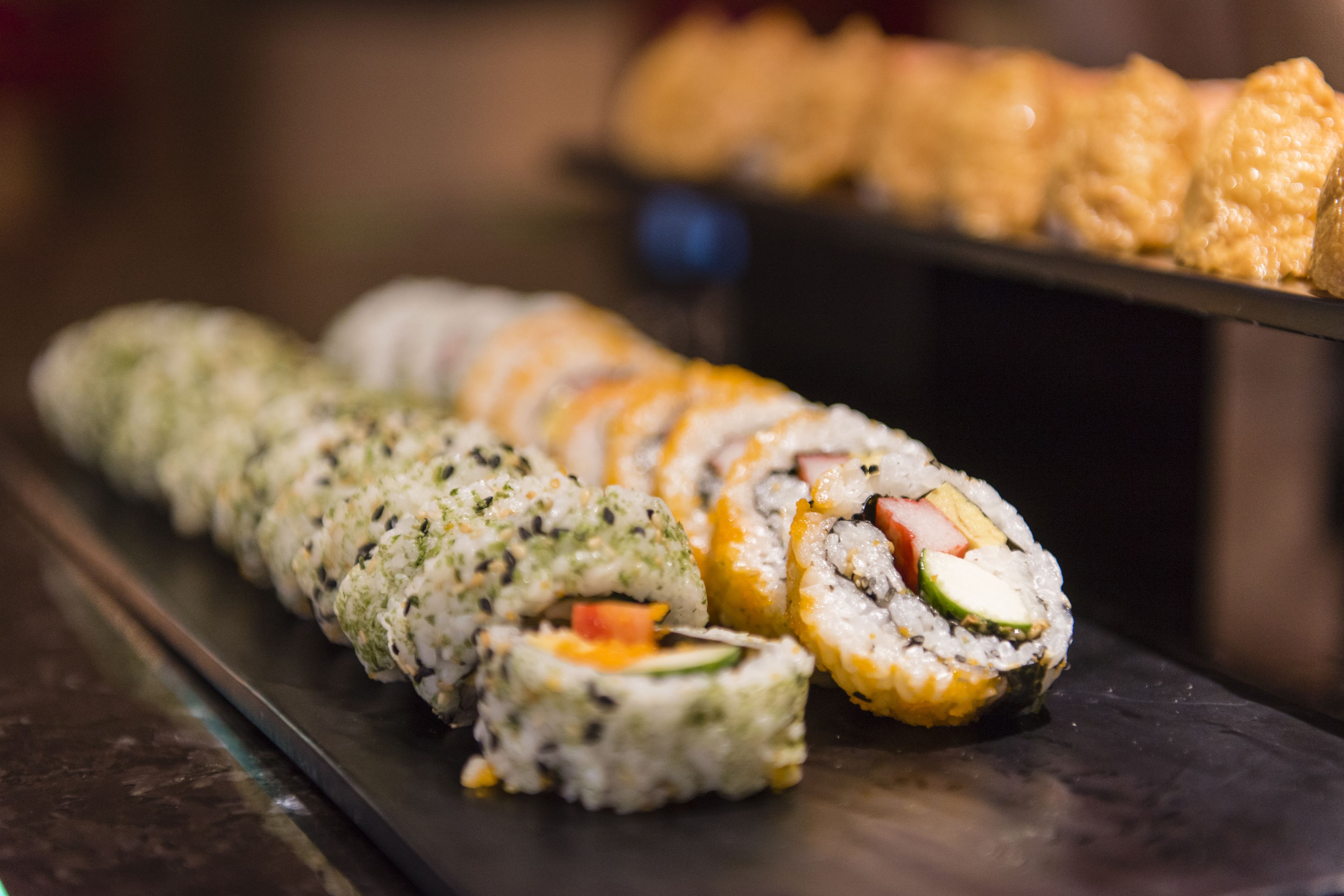 A sushi platter with various types of sushi rolls.