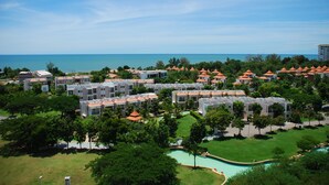 A resort with multiple buildings, a swimming pool, and a view of the ocean. - The Legend Boathouse - 904 (Cha-am)