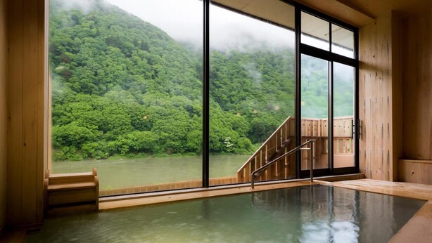 A hot spring room with large windows overlooking a forested hillside. - Beni (Tozawa)