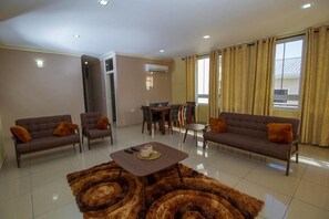 Apartment, 3 Bedrooms | Living area | Flat-screen TV