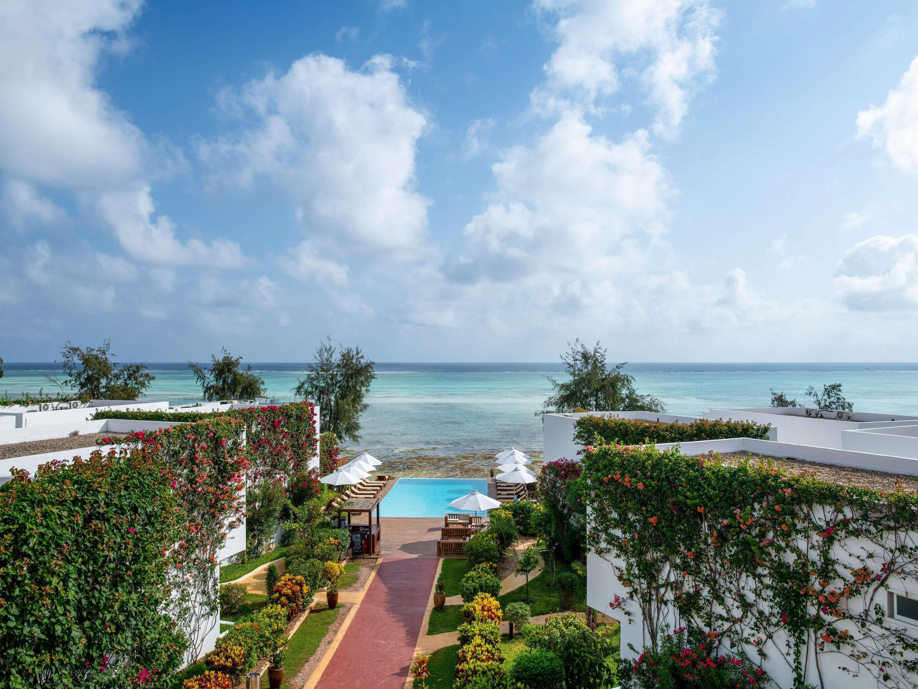 A resort with a pool, lounge area, and ocean view.