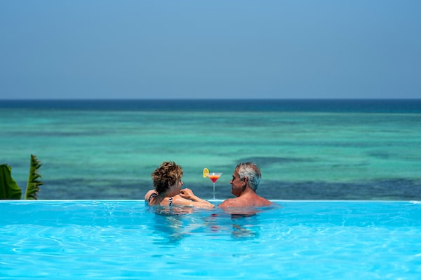 2 outdoor pools, an infinity pool, pool umbrellas, pool loungers