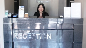 A reception desk with a logo and the word "RECEPTION" on it. - Citra Suites Surabaya (Surabaya)