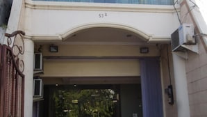 A building entrance with a glass door, a number 53A, and a metal gate. - Citra Suites Surabaya (Surabaya)