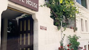 A building with a sign reading "AVLU CAVE HOUSE" and a "RECEPTION" sign pointing to the right. - Avlu Cave House  (Nevsehir)