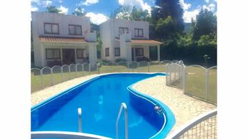 Outdoor pool, open 9 AM to 8 PM, pool umbrellas, pool loungers