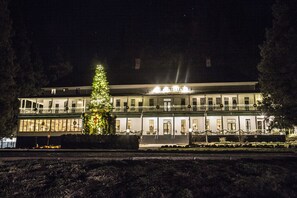 Vista frontal de la propiedad por la tarde o noche