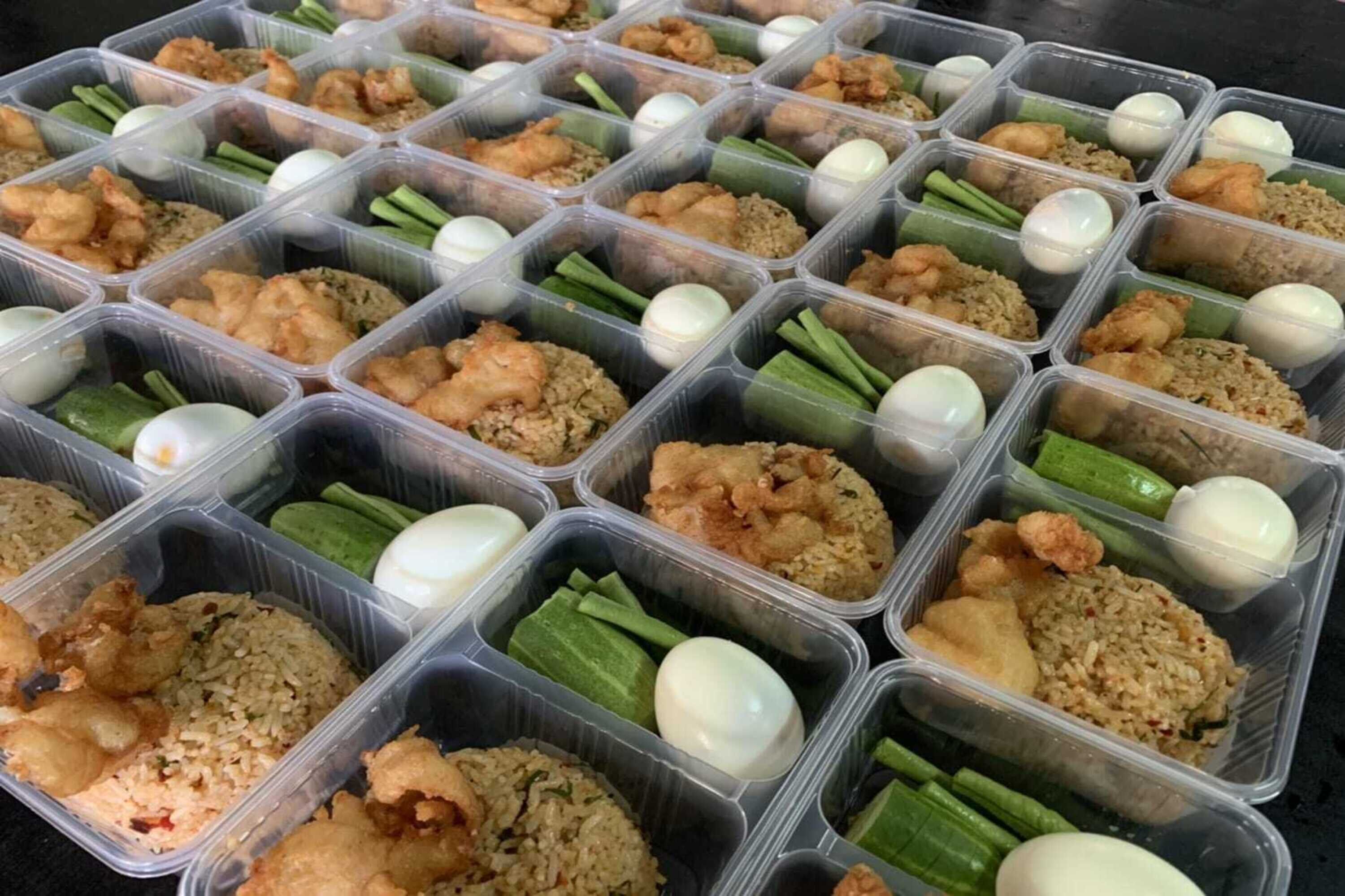 Multiple food containers with various dishes including fried rice, shrimp, and boiled eggs.