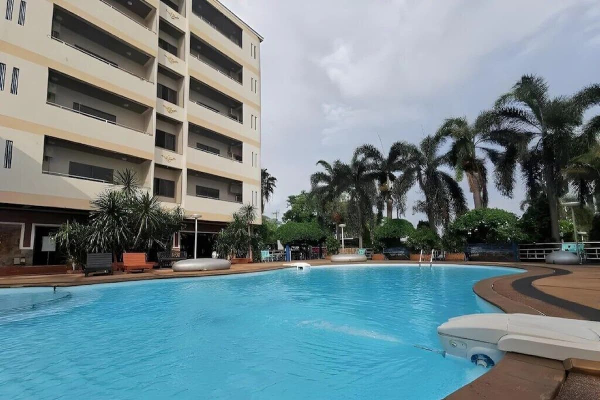 A swimming pool with a building in the background.