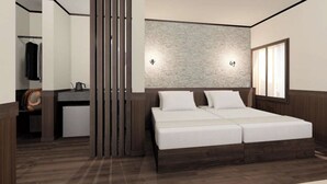 A modern bedroom with a large bed, a wooden headboard, a small desk, and a wardrobe. - Park Lodge Sekine (Myoko)