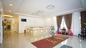 A hotel lobby with a reception desk, a chandelier, a large window with curtains, and a red carpet. - MNY Hotel & Resort (Pangkor Island)