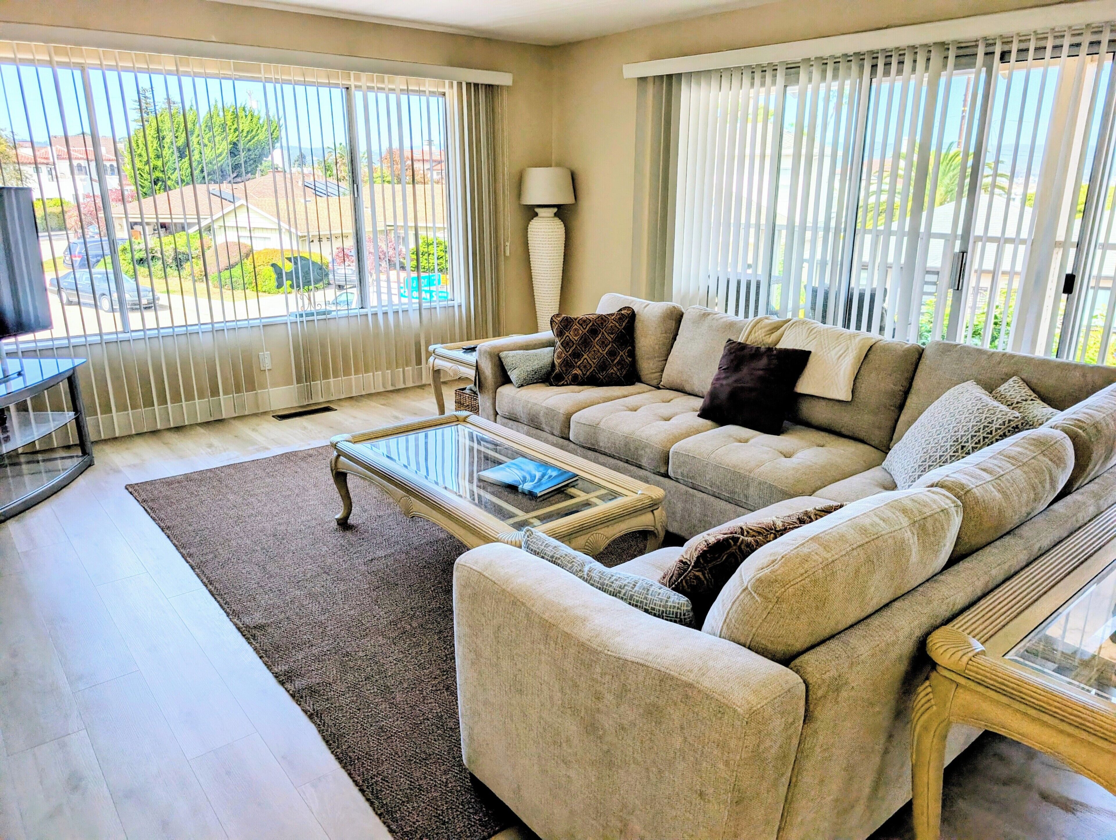 A living room with a sofa, a coffee table, and a lamp.
