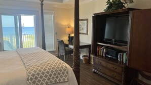 A hotel room with a bed, a desk, a television, and a bookshelf. - 10 Star Reviews-BEACHFRONT Home, N Cape by State Park, Elevator, Screen Porch  (Cape San Blas)