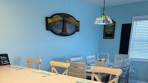 A kitchen with a large island, wooden cabinets, and a blue wall.