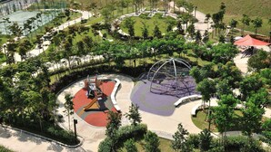 An aerial view of a park with a playground, walking paths, and landscaped areas. - New Wave Hotel Nilai 1 (Nilai)