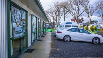 Guests can park their vehicles in the designated area adjacent to the building.
