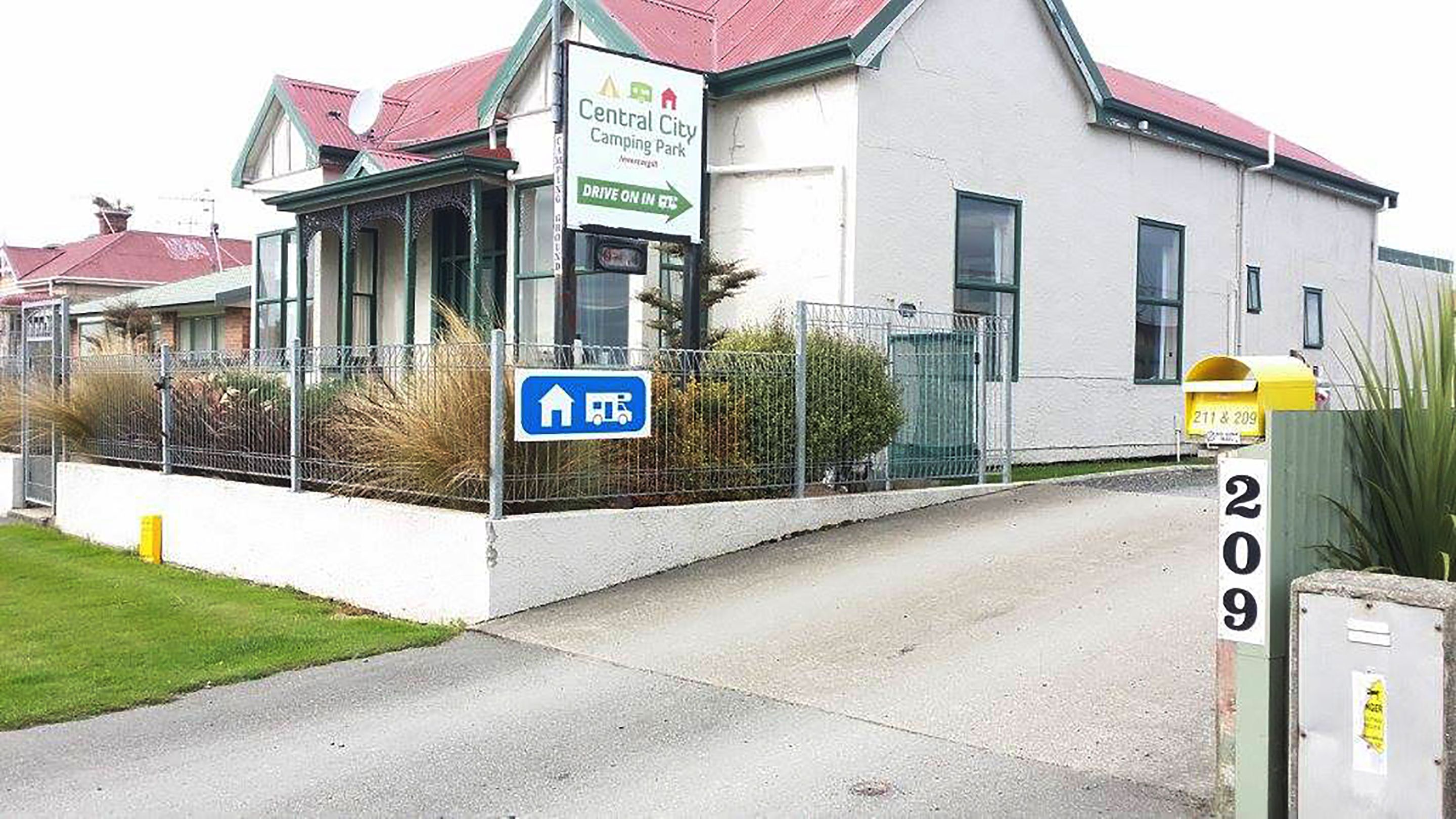 A building labeled "Central City Camping Park" with a sign indicating a drive-on-in parking area.