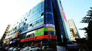 A multi-story hotel with a modern glass facade, multiple floors, and a prominent 'HOTEL' sign. - Hotel The Ann (Changwon)