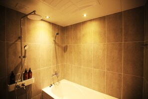 Habitación doble Deluxe | Baño | Tina y regadera independientes y tina profunda 