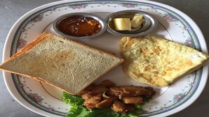 A plate with toast, fried chicken, lettuce, and condiments. - Hotel Namtso (Kathmandu)
